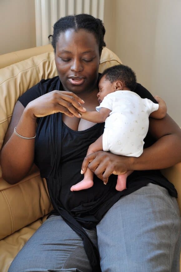 Mum holding a 2 week old baby